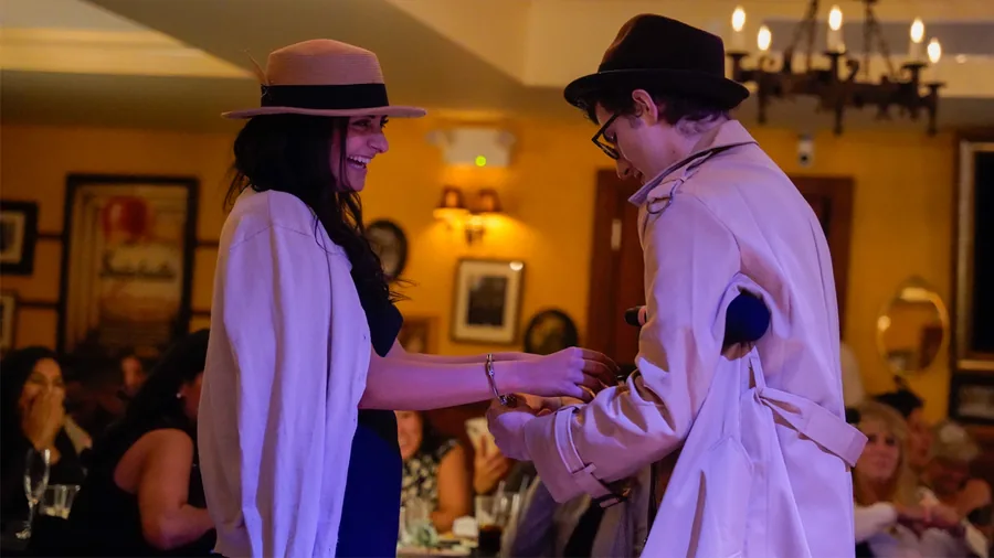 A Murder Mystery Company detective questioning a guest at a Baltimore show